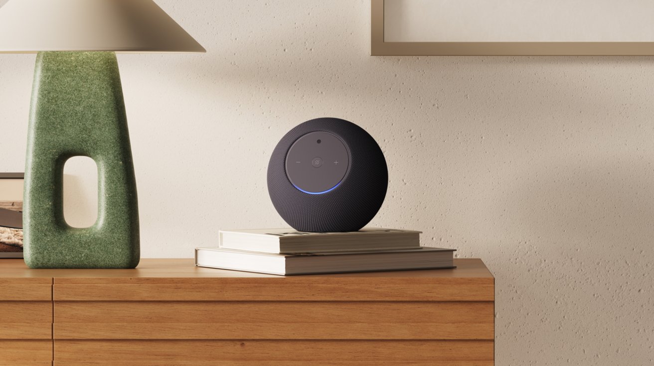 Black spherical smart speaker with glowing blue ring sits on stacked books atop a wooden dresser, next to a green ceramic lamp, against a neutral wall in a minimalist room — Pictur