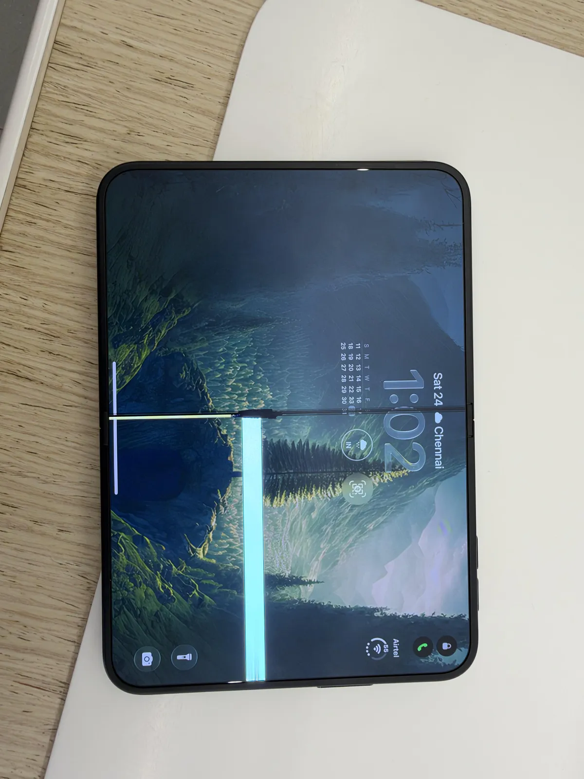 u/Vishnu_RK in Chennai. A wide bright band runs along the hinge, and a dark line crosses the screen. The lock screen reads Saturday 24 and Chennai.