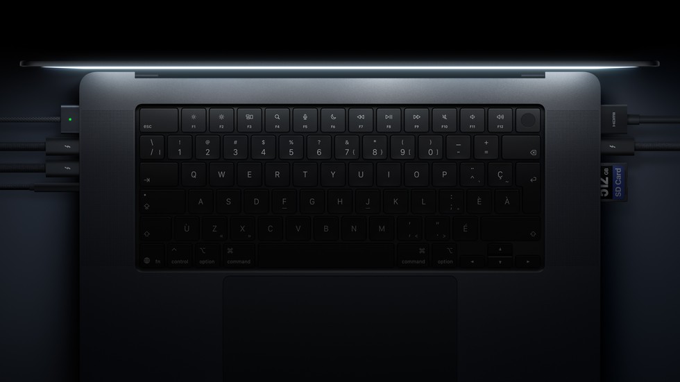 The keyboard and ports. Three cables are plugged in on the left. HDMI and an SD card are on the right. Touch ID is the round key at the top right of the keyboard.