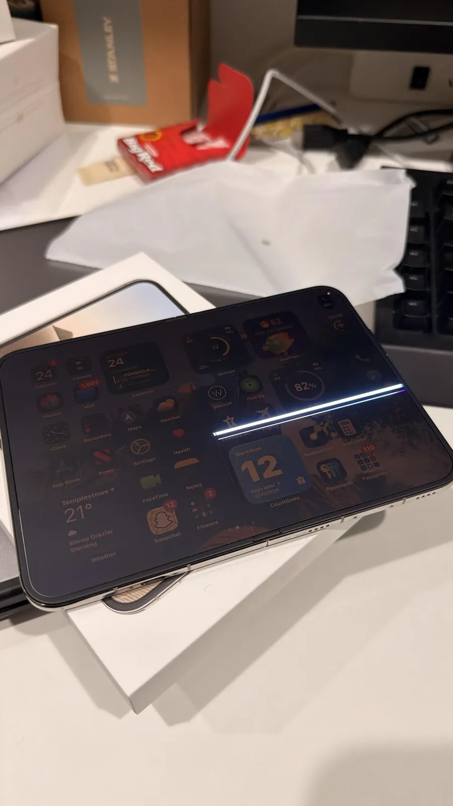 The same phone, open to the home screen. The bright line stays on the right half.