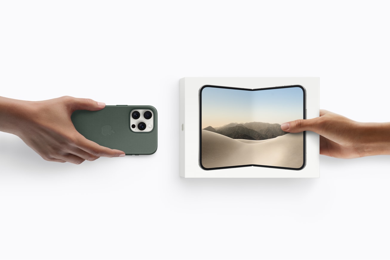 One hand holds an unboxed iPhone device, while another hand holds a boxed iPhone Duo. — Picture from apple.com